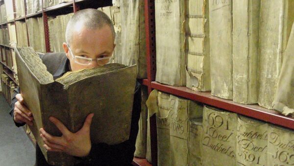 Profesor Matija Strlic oliendo un libro antiguo en el Archivo Nacional de Países Bajos - Sputnik Mundo