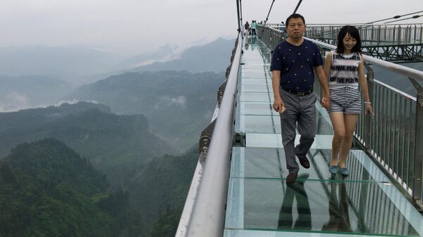 Unas personas caminan sobre un puente de vidrio en China (archivo) - Sputnik Mundo