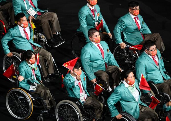 Debido al aumento de los casos de COVID-19 en Tokio, el tradicional relevo al aire libre tuvo que ser cancelado. En la foto: los miembros de la selección paralímpica de China en la ceremonia de inauguración de los Juegos Paralímpicos de Tokio. - Sputnik Mundo