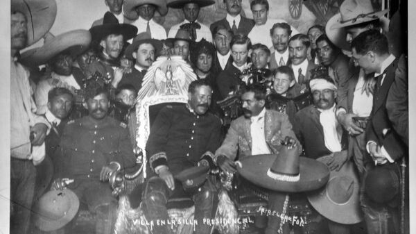 Francisco Villa, héroe revolucionario mexicano sentado en la silla presidencial, y Emiliano Zapata a su lado  - Sputnik Mundo