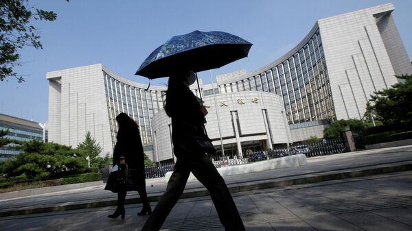 La gente pasa frente a la sede del Banco Popular de China, en Pekín, China - Sputnik Mundo