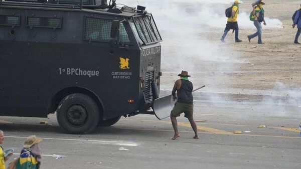 Los manifestantes atacan un vehículo de la policía brasileña - Sputnik Mundo