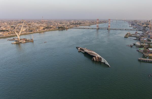 Esta fotografía aérea muestra el casco volcado de &quot;Al Mansur&quot;, el yate del derrocado presidente iraquí Sadam Husein, en la ruta navegable Chat el Arab,​ en Basora, Irak. - Sputnik Mundo