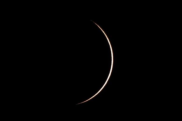 Durante el eclipse anular, la Luna solamente cubría el centro del Sol, por lo que podía verse un anillo de fuego en el cielo. En la foto: el eclipse solar híbrido sobre Timor Oriental. - Sputnik Mundo