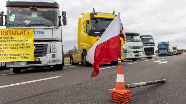 Una bandera polaca en los conos de tráfico durante el bloqueo en la frontera polaco-ucraniana. - Sputnik Mundo