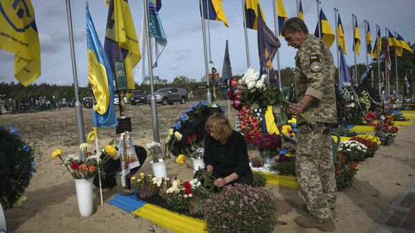 Familiares de un soldado ucraniano visitan su tumba (archivo) - Sputnik Mundo