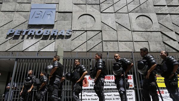 Riot police officers stand guard during a protest of metallurgical union workers demanding better labor conditions and against layoffs at the state-run oil company Petrobras, in Rio de Janeiro - Sputnik Mundo