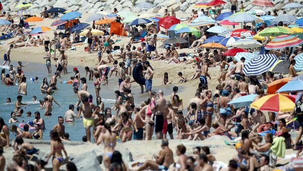 Gente pasa el tiempo en la playa cerca de Barcelona (Archivo) - Sputnik Mundo
