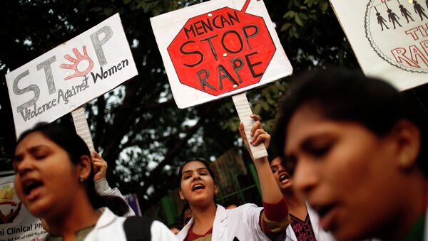 Indian physiotherapy students hold placards at a rally on the 1st anniversary of the fatal gang rape of a young woman in a bus New Delhi, India, Monday, Dec. 16, 2013. - Sputnik Mundo