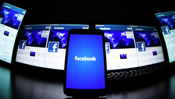 The loading screen of the Facebook application on a mobile phone is seen in this photo illustration taken in Lavigny May 16, 2012. - Sputnik Mundo
