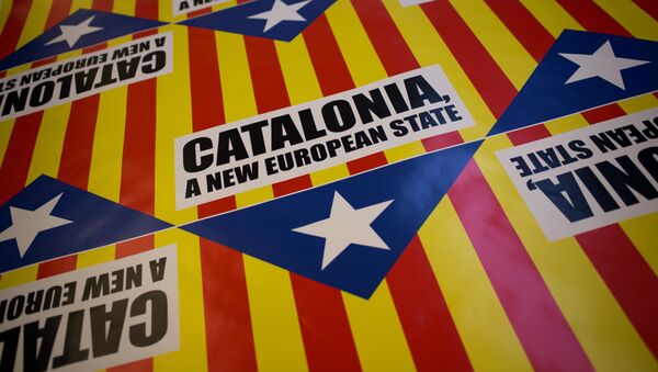 In this photo taken on Tuesday, Nov. 13, 2012, flags for sale that combines the slogan of EU aspiration with the red-and-yellow stripes, blue triangle and white star of the “estelada” flag that symbolizes Catalonia's independence drive are laid out in a printing shop in Girona, Spain. - Sputnik Mundo