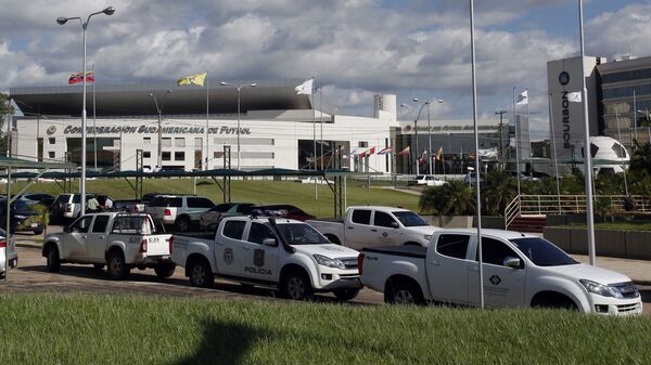 Police vehicles are parked outside the headquarters of the South American soccer confederation known as CONMEBOL in Asuncion, Paraguay, Thursday, Jan. 7, 2016 - Sputnik Mundo