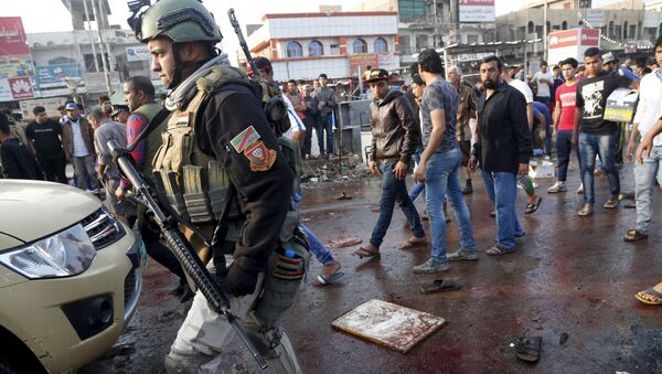 A soldier walks at the site of suicide blasts in Baghdad - Sputnik Mundo