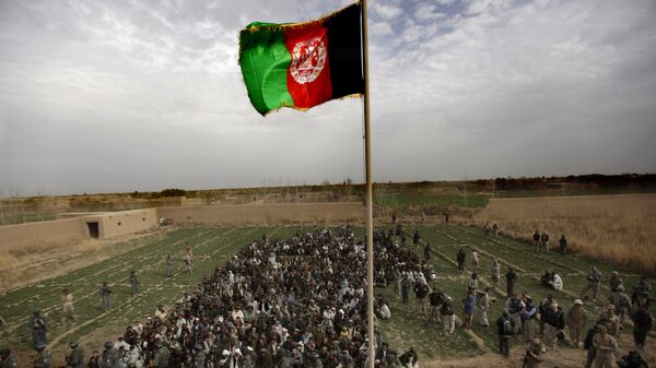 The Afghan national flag is hoisted during an official flag raising ceremony in Marjah on February 25, 2010. - Sputnik Mundo