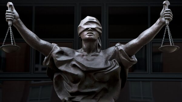 A statue of Justice is seen outside as a sentencing hearing takes place for Marcel Lehel Lazar, a hacker known as Guccifer, at the Albert V. Bryan US federal courthouse September 1, 2016 in Alexandria, Virginia. Lazar earlier pleaded guilty to unauthorized access to a protected computer and aggravated identity theft. 'Guccifer' allegedly published correspondence that led to the discovery of former US Secretary of State Hillary Clinton's private email server system. - Sputnik Mundo