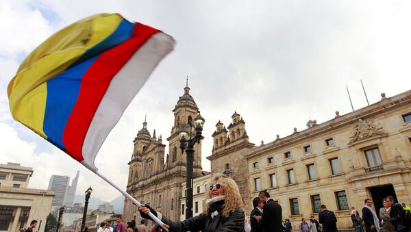 People demonstrate on the street as Colombia's President Juan Manuel Santos and Marxist FARC rebel leader Rodrigo Londono sign a new peace accord in Bogota - Sputnik Mundo