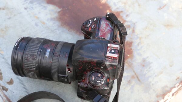 ATTENTION EDITORS - VISUALS COVERAGE OF SCENES OF DEATH OR INJURY - The blood stained camera of a photojournalist is seen after a secondary explosion in front of Dayah hotel in Somalia's capital Mogadishu - Sputnik Mundo