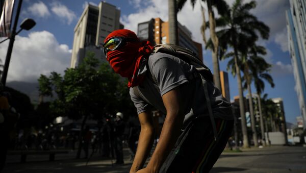 Protestante en Caracas, Venezuela - Sputnik Mundo