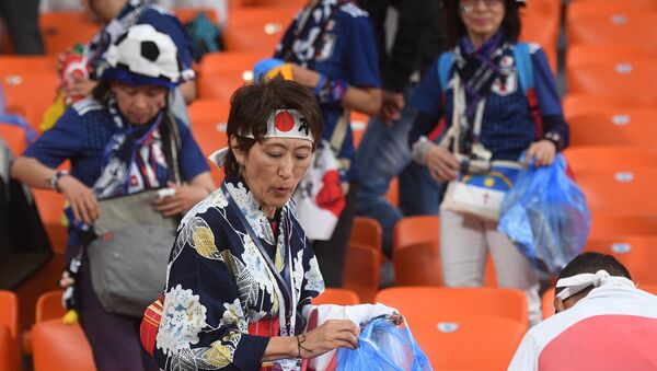 Los hicnhas de Japón limpian el estadio tras el partido con Senegal - Sputnik Mundo