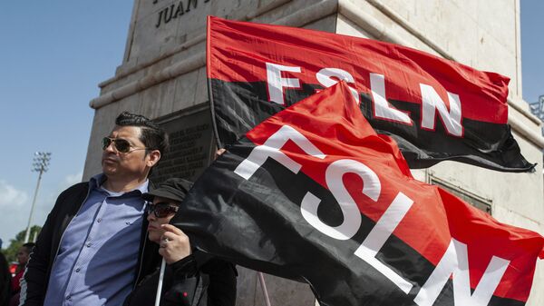 Sandinista porta las banderas del FSLN en el 39 Aniversario de la Revolución nicaraguense - Sputnik Mundo
