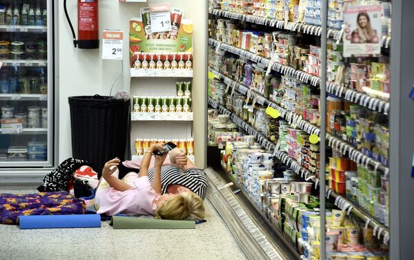 Unas personas están escondiéndose del calor en un supermercado de Finlandia - Sputnik Mundo