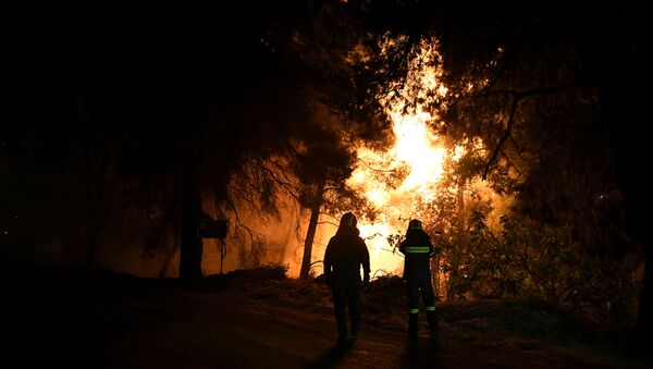 Los bomberos observan el aumento de las llamas durante un incendio forestal, Grecia (archivo) - Sputnik Mundo