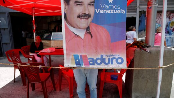 Un cartel con el retrato del presidente de Venezuela, Nicolás Maduro - Sputnik Mundo