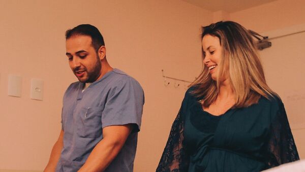 El obstetra brasileño Fernando Guedes da Cunha baila con su paciente, Camila Rocha, durante el trabajo de parto - Sputnik Mundo