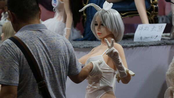 Un hombre toca a una muñeca sexual durante una exposición en Zhengzhou, China - Sputnik Mundo