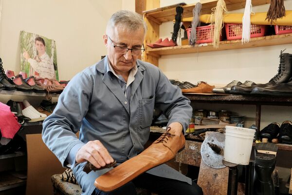Румынский сапожник Григоре Луп с парой кожаных ботинок, позволяющих эффективней соблюдать социальную дистанцию - Sputnik Mundo